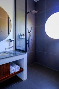 a bathroom with a shower with a sink and a mirror at Serenity Home in Siem Reap +71 photos