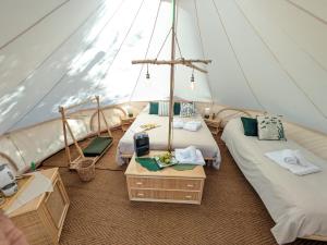 a room with two beds in a tent at I Giardini del Caramante in Soverato Marina