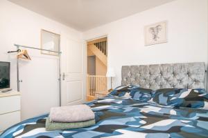 ein Schlafzimmer mit einem Bett mit einer Bettdecke aus Kamel in der Unterkunft 5 bed house with free secure parking in pleasant quiet location in Wolverhampton