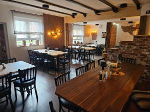 a restaurant with wooden tables and chairs in a room at Gasthof Wolfs Stuben in Reichenbach an der Fils