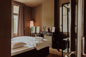 Ένα ή περισσότερα κρεβάτια σε δωμάτιο στο Boutique Hotel Blue - Quality Lodgings