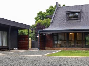 een huis met een zwart dak en een gebouw bij Fossil Lane in Clarens
