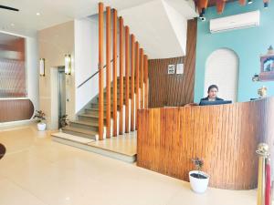a woman sitting at a desk in a lobby at Hotel Casa Del Sol in Raipur