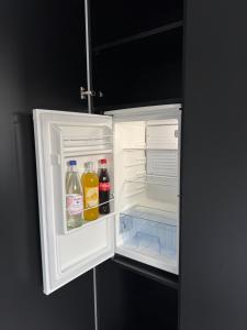 an open refrigerator with drinks in the door at Studio am Waldrand in Bad Hersfeld