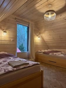 Postel nebo postele na pokoji v ubytování Bursztynowy domek