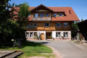 een huis met een fiets voor het huis bij Pension Vogtsmichelhof - Haupthaus in Alpirsbach