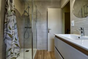 a bathroom with a shower and a sink at TY Lavarion in Le Bono +45 photos