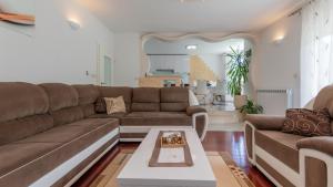 a living room with a couch and a table at Villa Rusula -Makarska by Villas Guide in Zagvozd