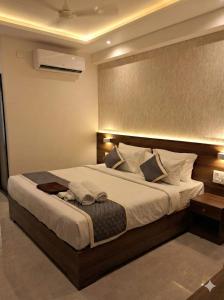 a bedroom with a large bed in a room at Hanuman Heritage in Chikmagalūr