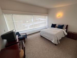 Postel nebo postele na pokoji v ubytování D'Acosta Hotel Belencito + 17 fotografií