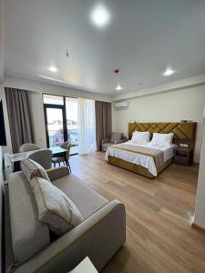 a large hotel room with a bed and a couch at Meloso in Kobuleti