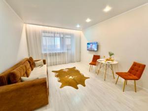 a living room with a couch and a table at ЖК Абая 5 in Kokshetau