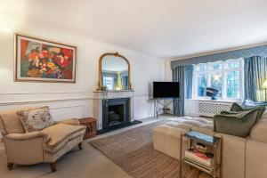 a living room with a couch and a fireplace at Sobo House in Southbourne