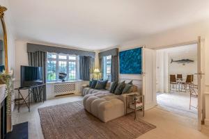 a living room with a couch and a television at Sobo House in Southbourne
