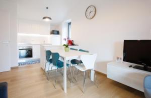 a kitchen and living room with a table and chairs at La casa di Giacomo & Vanille in Morbegno