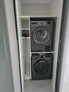 a washing machine and a washer and dryer in a room at Laguna Grove 20 in Knysna