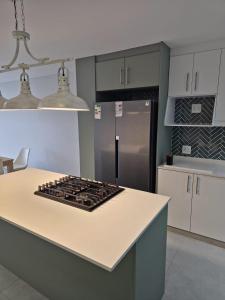 a kitchen with a stove and a refrigerator at Laguna Grove 20 in Knysna +12 photos