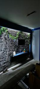 een badkamer met een wastafel en een stenen muur bij Maka's Design Suite-Trikala in Tríkala