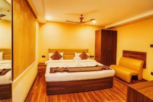 a hotel room with a bed and a chair at Arcadian Hotel in Gangtok