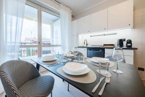 a kitchen with a table with plates and glasses on it at V-Home Holiday Moro 60 in Grassobbio