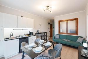 a kitchen and a living room with a table and chairs at V-Home Holiday Moro 60 in Grassobbio