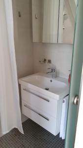 a bathroom with a white sink and a mirror at Ferienwohnung und Pension Antje Ekert in Uhldingen-Mühlhofen +22 photos