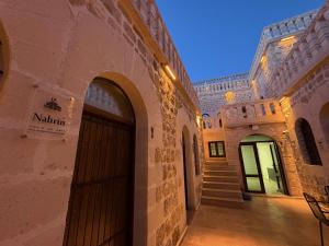 a building with a door and a stairway at Arami Han Konağı in Mardin