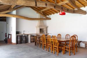 a dining room with a wooden table and chairs at Private Villas & Boutique Hotel - Casa Da Brêa in Viana do Castelo