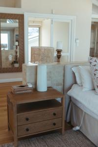 a bedroom with a bed and a table with a mirror at Dune Rose Yzerfontein Villa in Yzerfontein +48 photos