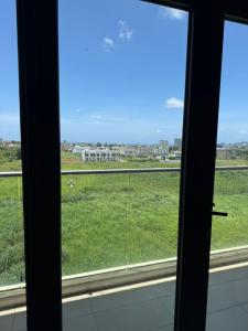 a view of a field from a window at Le Meritt Appartments in Quatre Bornes