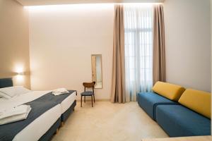 a hotel room with a bed and a couch at Hotel San Lorenzo Boutique Catedral in Valencia