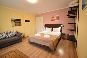 a bedroom with a bed and a couch at Simada Green Guesthouse in Varshets