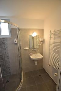 a bathroom with a sink and a shower at Simada Green Guesthouse in Varshets
