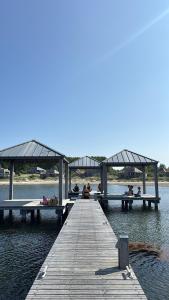 a group of people sitting on a dock in the water at Beach Resort Punt West in Ouddorp +5 photos