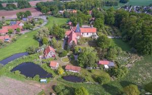 an aerial view of a large house with a bridge at Gästehaus Malgarten in Bramsche