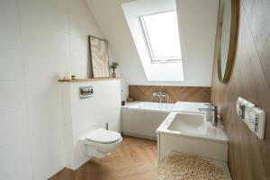 a bathroom with a toilet and a sink and a tub at Willa Aleksandria in Konopiska +24 photos