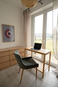 a office with a desk and a laptop on a table at Willa Aleksandria in Konopiska