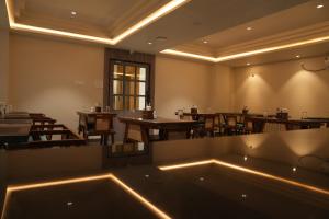 a restaurant with tables and chairs and a large tub at Sasya Elegance - A Boutique Hotel in Lingampalli