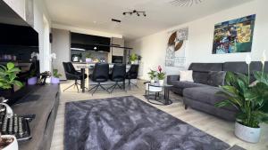 a living room with a couch and a table at FeWo-Brombachseeblick in Absberg +9 photos