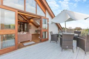 a patio with a table and an umbrella at 3 Bed in Croyde oc-t30753 in Croyde