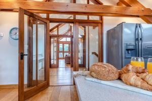a kitchen with a counter with bread and a refrigerator at 3 Bed in Croyde oc-t30753 in Croyde +17 photos