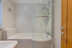 a white bathroom with a tub and a sink at 3 Bed in Croyde oc-t30753 in Croyde