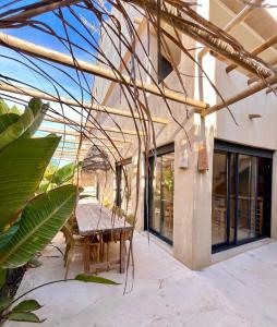 a patio with a table and chairs in front of a building at Apartamentos Flores playa in La Mata