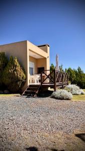 a house with a wooden ramp leading to a house at ARROYO SUITE HOUSE in Mina Clavero
