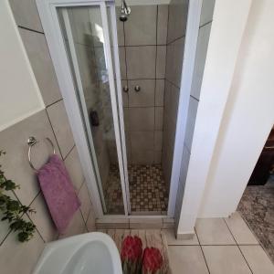 a shower in a bathroom with a purple towel at Albert's Nest in Kimberley +13 photos