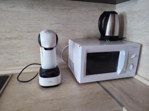 a white blender sitting next to a microwave at "Mountain Dream" Apartments 200m from Ski Road in Bansko