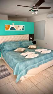 a bedroom with a large bed with a blue blanket at ARROYO SUITE HOUSE in Mina Clavero +62 photos