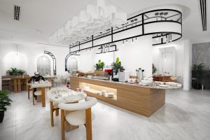 a restaurant with a counter with tables and chairs at Liora Boutique in Riyadh