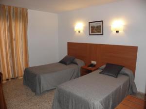 Postel nebo postele na pokoji v ubytování Hotel Jardín