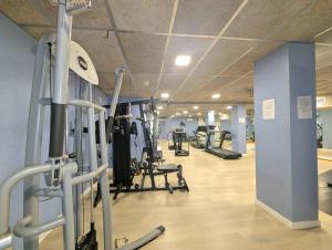 a gym with several treadmills and exercise bikes at Relax en Lloret con Gym y Piscina by Host&Joy in Lloret de Mar